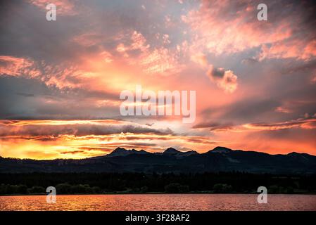 Fiery pink and orange sunset over mountains Stock Photo