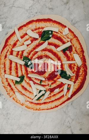 Margherita pizza base, isolated in a pizzeria kitchen. Stock Photo