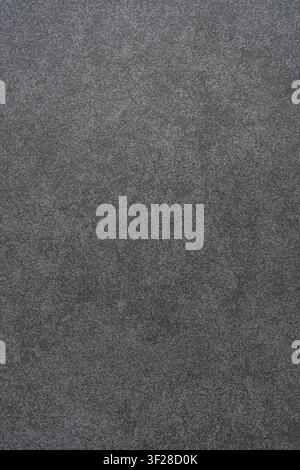 Fine texture of dark grey matte sandpaper sheet with abrasive grain surface. Stock Photo