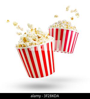 Popcorn flying out of red white striped paper box isolated on white background. Splash, levitation of popcorn grains. Stock Photo