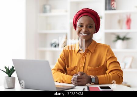 Smiling Young Black Woman Working On Laptop In Home Office, Business Concept Stock Photo