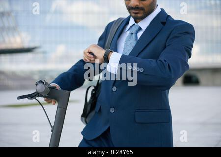 Indian Businessman Checking Smartwatch While Commuting to Work Stock Photo