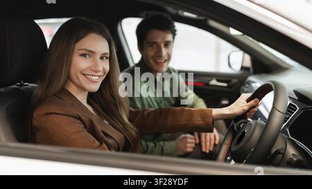 Happy Young Caucasian Couple Smiling Inside Car, Enjoying Time Together, Road Trip Concept Stock Photo