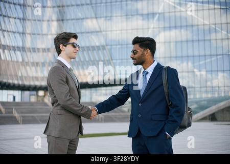 Indian Businessman Shaking Hands during Corporate Meeting Stock Photo