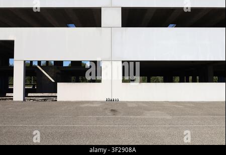 Industrial prefabricated white concrete building under construction. Road in front. Background for copy space. Stock Photo
