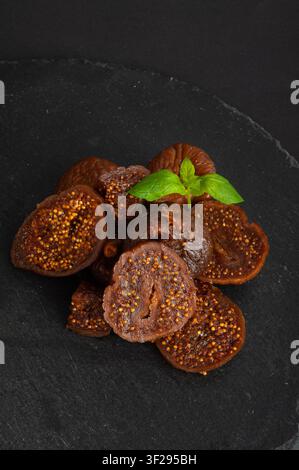 Dry Fig, Dried Ficus Carica Fruit, Sweet Healthy Diet, Tropical Dessert, Wrinkled Dehydrated Snack, Dry Figs on Black Background Stock Photo