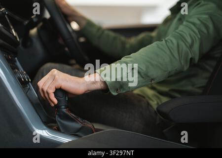 Unrecognizable Man Driving Car With Manual Transmission, Focusing On Gear Shift Stock Photo