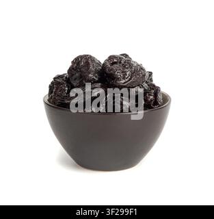 Dry Plums Isolated, Dried Black Fruits in Bowl, Prune Group, Natural Dessert, Healthy Diet, Dry Plum Fruit on White Background Stock Photo