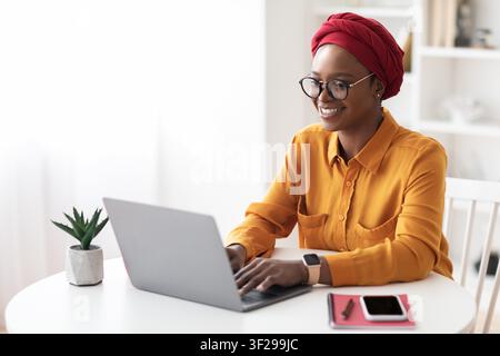 Smiling Black Woman Working On Laptop At Home Office, Business Concept Stock Photo