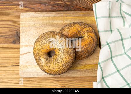 Poppy Seed Bagels on Wood Rustic Table, Round Bread Bun, Poppyseed Wheat Bakery for Breakfast, Plain Circle Bagel Bread on Wooden Background Stock Photo
