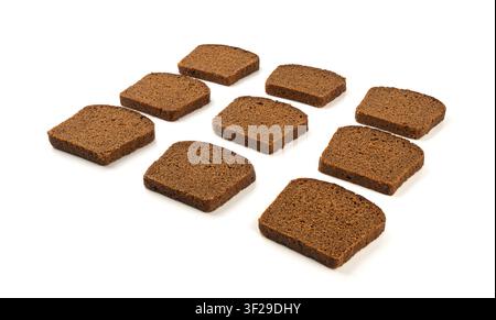 Black rye bread isolated, dark brown sliced loaf, sourdough borodinsky rugbrod square slices with coriander on white background Stock Photo