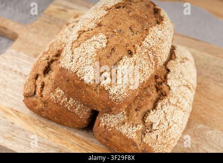 Whole wheat brown bread, fitness pumpkin carrot buns with seeds, cereal bread grain bun with rye on rustic background Stock Photo