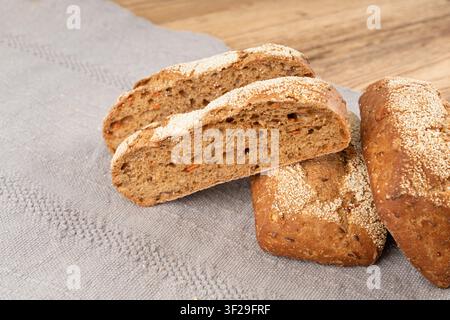 Whole wheat brown bread, fitness pumpkin carrot buns with seeds, cereal bread grain bun with rye on rustic background Stock Photo
