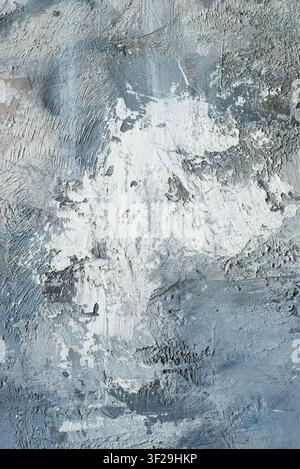 Abstract grunge background with rough textured grey concrete and white plaster brush strokes. Stock Photo