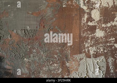 Abstract brown and grey textured background with rough plaster smears, scratches, and distressed grunge effect. Stock Photo