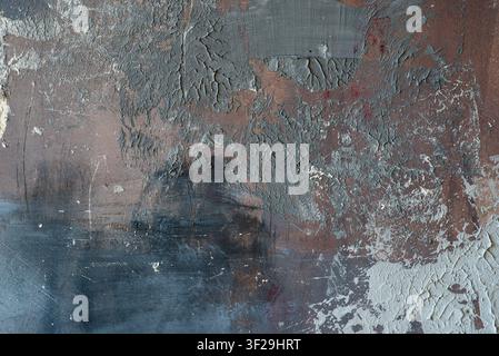 Dark abstract grunge background with rough cement texture, brown and grey plaster smears, and black stains. Stock Photo