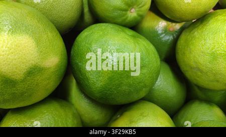 Fresh green lime fruits background close up Stock Photo
