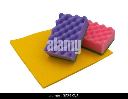 Purple and pink dishwashing sponges with a yellow cloth on a white background. Stock Photo