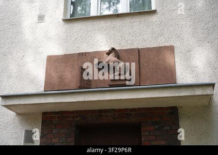 Berlin, Germany - July 17, 2026: Art Déco detail with horse relief and the year 1929 on a residential building in Trautenauer Straße, Karlshorst. Stock Photo