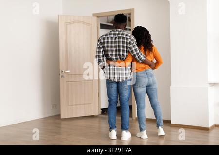 Happy Black Couple Embracing In New Home, Unrecognizable, Couple Love Concept Stock Photo