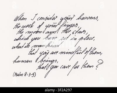 Handwritten text of Psalm 8:3-5 in elegant cursive script using black fountain pen ink on white paper. The passage reflects on the beauty of the heave Stock Photo