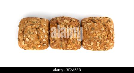Pumpkin seeds bread isolated, three breakfast rolls with pepita seeds. Fitness square bun, healthy burger, zucchini seeds bun on white background top Stock Photo