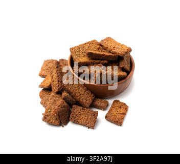 Rye Croutons in Wood Bowl Isolated, Homemade Brown Bread Rusks, Crispy Bread Cubes Scattered Pile, Dry Rye Crouoton Crumbs, Brown Roasted Salted Crack Stock Photo