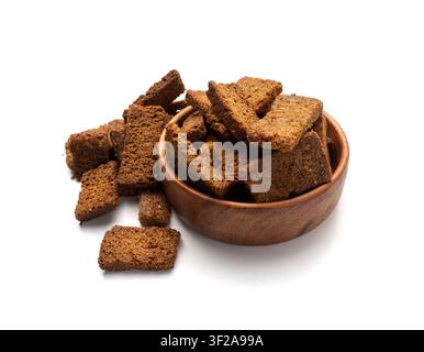 Rye Croutons in Wood Bowl Isolated, Homemade Brown Bread Rusks, Crispy Bread Cubes Scattered Pile, Dry Rye Crouoton Crumbs, Brown Roasted Salted Crack Stock Photo