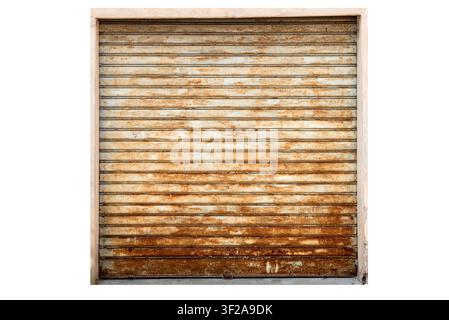 Old weathered and rusted metal roller shutter door of a garage or shop. Grunge industrial background texture with heavy rust corrosion on iron surface Stock Photo