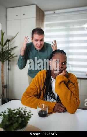 Couple having an argument in kitchen with woman ignoring man Stock Photo