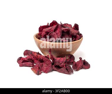 Dry beetroot chips in wood bowl isolated, dried sliced red beet flakes pile, beet root pieces and chips, dehydrated deep fried vegetable root heap on Stock Photo