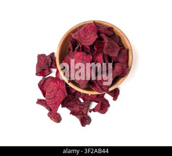Dry beetroot chips in wood bowl isolated, dried sliced red beet flakes pile, beet root pieces and chips, dehydrated deep fried vegetable root heap on Stock Photo
