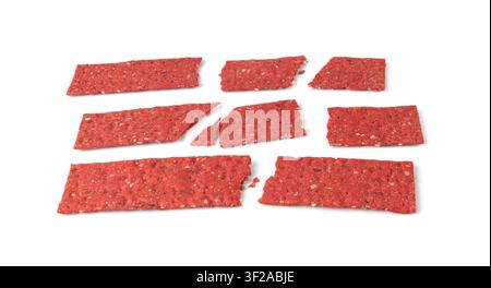 Beetroot crackers pieces isolated, crumbled thin rusk beet root bread pile, broken red diet multigrain crispbread with various seeds, crisp bread, lon Stock Photo