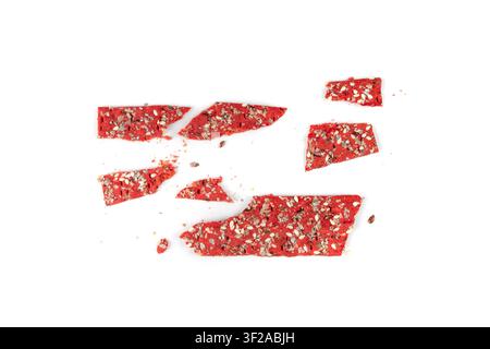 Beetroot crackers pieces isolated, crumbled thin rusk beet root bread pile, broken red diet multigrain crispbread with various seeds, crisp bread, lon Stock Photo