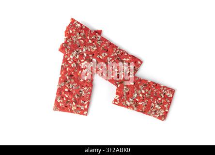 Beetroot crackers pieces isolated, crumbled thin rusk beet root bread pile, broken red diet multigrain crispbread with various seeds, crisp bread, lon Stock Photo