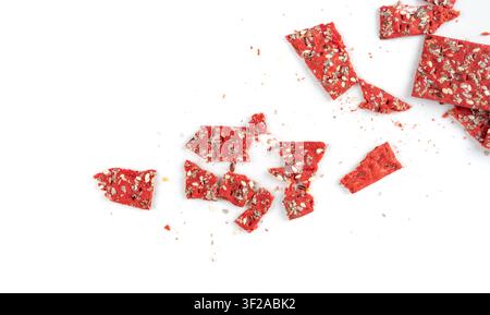 Beetroot crackers pieces isolated, crumbled thin rusk beet root bread pile, broken red diet multigrain crispbread with various seeds Stock Photo
