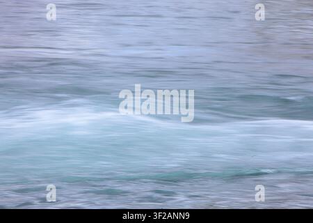 water in motion creates an interesting background, blurred with camera motion. Stock Photo