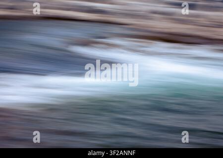 water in motion creates an interesting background, blurred with camera motion. Stock Photo