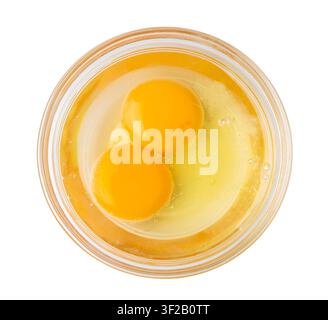 Two Broken Eggs in Bowl Isolated, Raw Yolk and White, Fresh Broken Organic Chicken Eggs on White Background Stock Photo