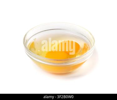 Two Broken Eggs in Bowl Isolated, Raw Yolk and White, Fresh Broken Organic Chicken Eggs on White Background Stock Photo