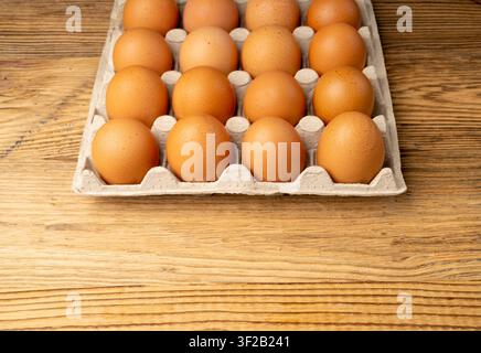 Egg Tray on Wooden Rustic Background, Twenty Brown Eggs Pack, 20 Fresh Organic Eggs in Paper Container Stock Photo