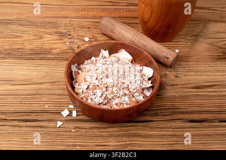 Broken Egg Shell in Bowl, Crushed Eggshell, Calcium Supplement, Cracked Eggshells, Natural Compost Ingredient, Broken Egg Shells on Wood Background To Stock Photo