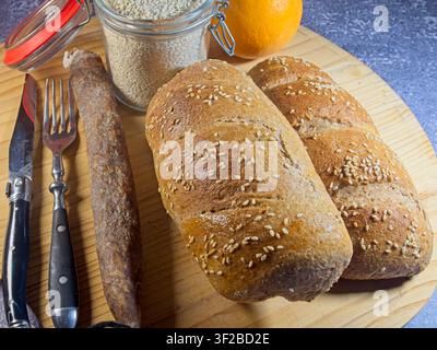 Fresh bread and rolls for breakfast…  Round rye bread baked with sourdough.  A wide selection of baked goods awaits—ideal for advertising and websites Stock Photo