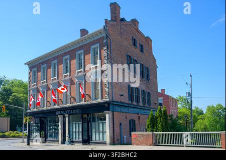 Waddell Hotel with Canadian flags on a restored nineteenth-century brick building Stock Photo