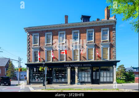 Waddell Hotel with Canadian flags on a restored nineteenth-century brick building Stock Photo