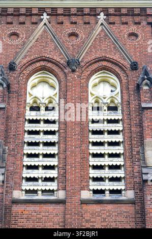 Historic church windows with decorative brickwork and louvered openings. Port Hope United Church. Stock Photo