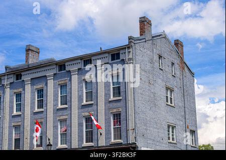 Colonial brick building with Canadian flags, old architecture is common in the small town Stock Photo