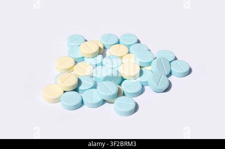 Blue and Yellow Pills Pile Isolated on White Background Stock Photo