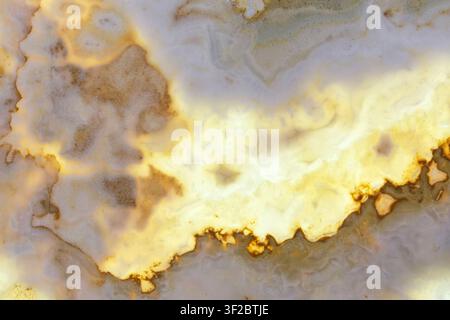 Marble on background of bright light. Yellow and white Stock Photo