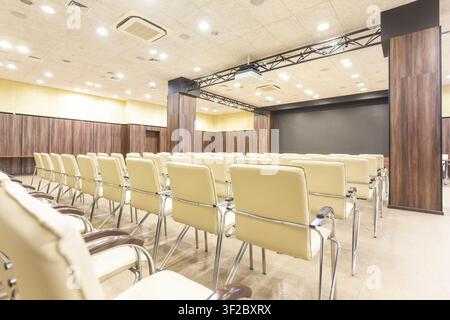 Audience for presentations. Large hall with wooden walls Stock Photo